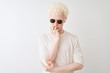 © Krakenimages.com - Young albino blond man wearing t-shirt and sunglasses over isolated white background thinking looking tired and bored with depression problems with crossed arms.