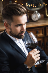 Wall Mural - Handsome bearded man with a glass of red wine