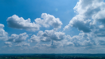 Wall Mural - White and Dark Clouds Floating in the Bright Blue Skies