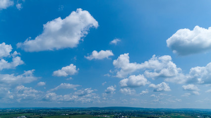 Wall Mural - White Clouds Floating in the Bright Blue Skies