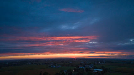 Wall Mural - An Aerial View of a Sunset with Red and Blues on a Summer Night