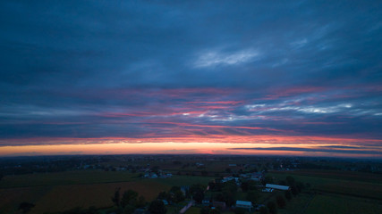 Wall Mural - An Aerial View of a Sunset with Red and Blues on a Summer Night