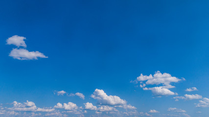 Wall Mural - White Clouds Floating in the Bright Blue Skies