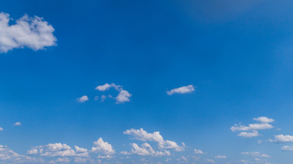 Wall Mural - White Clouds Floating in the Bright Blue Skies