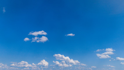 Wall Mural - White Clouds Floating in the Bright Blue Skies