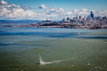 Wall Mural - San francisco skyline with a few sailboats in the bay on a bright sunny clear windy day