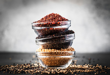 Black, White And Red Quinoa In Bowls, Raw Quinoa Groats Set On Gray Kitchen Table, Copy Space, Selective Focus