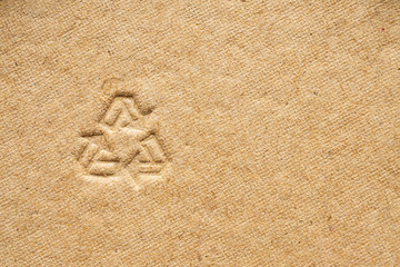 recycle sign on brown cardboard paper texture background