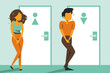 Woman and man standing at the closed toilet door