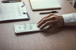 © wutzkoh - Partner has made a fraud in the contract of sale and being handed a cash and pen to the businessman signing the contract corruption bribery concept.