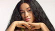 beauty mixed race african american model in studio portraits with long hair wig natural makeup. Face rest on hands