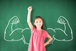 © Tom Wang - little girl standing against chalkboard and strong winner concept