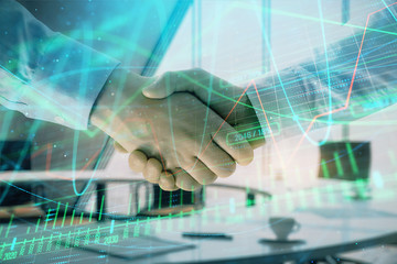 Multi exposure of financial graph on office background with two businessmen handshake. Concept of success in business