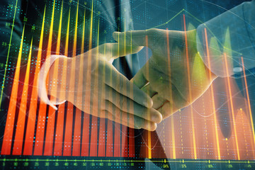 Multi exposure of forex graph on abstract background with two businessmen handshake. Concept of success on stock market