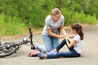 © Pixel-Shot - Mother helping her little daughter after falling off bicycle outdoors