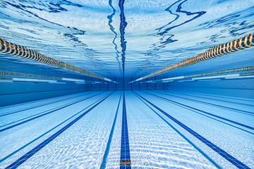 Wall Mural - Olympic Swimming pool under water background.