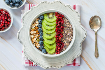 Canvas Print - Summer porridge with mixed seeds and fresh fruit - blueberries, pomegranate and kiwi. Healthy breakfast.