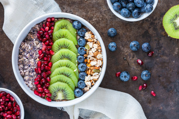 Sticker - Summer porridge with mixed seeds and fresh fruit - blueberries, pomegranate and kiwi. Healthy breakfast.