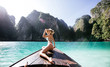 © oneinchpunch - Young woman making a tour on the long tail boat, going to phi phi island