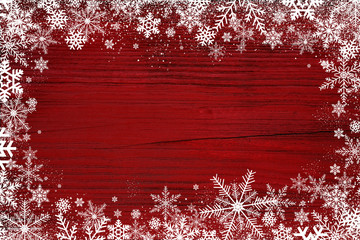 Wall Mural - Red Christmas winter background with snowflakes on wood