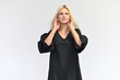 © Вячеслав Чичаев - Portrait of a cute girl, a young blonde woman with beautiful curly hair in a black dress on a white background. Beauty, brightness, smile, emotions.