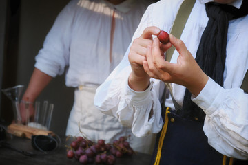 Winemaking in France. Winemaker shows how to create wine from grapes. A man holds a large grape in his hands.