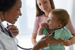 © lordn - Mother and her baby, visiting the doctor for a medical examination. Pediatrician doing an infant medical exam listening with a stethoscope.