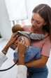 © lordn - Mother and her baby, visiting the doctor for a medical examination. Pediatrician doing an infant medical exam listening with a stethoscope.
