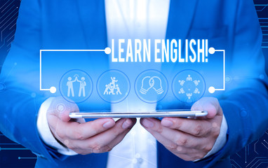 Poster - Text sign showing Learn English. Business photo text gain acquire knowledge in new language by study Male human wear formal work suit presenting presentation using smart device