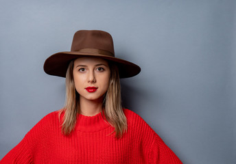 Wall Mural -  young woman in red sweater and hat