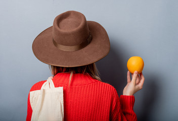 Poster - woman in red sweater with orange and bag