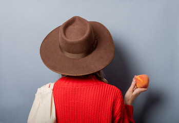 Wall Mural - woman in red sweater with peach and ba