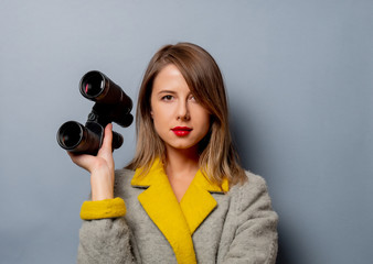 Sticker - style woman in coat with binoculars