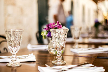 Wall Mural - Vintage glasses table setting in a summer restaurant