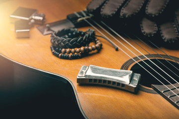 Wall Mural - vintage harmonica on acoustic guitar