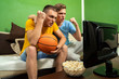 © phoenix021 - Brothers cheering watching basketball on TV