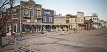 Wide Angled View Of A Rustic Antique Western Town With Various Businesses. 3d Rendering