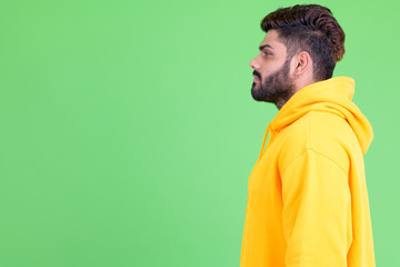 Wall Mural - Profile view of young overweight bearded Indian man