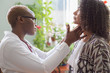 © Алексей Доненко - african female doctor watching patient with sore throat
