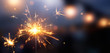 © phive2015 - Glittering burning sparkler against blurred bokeh light background