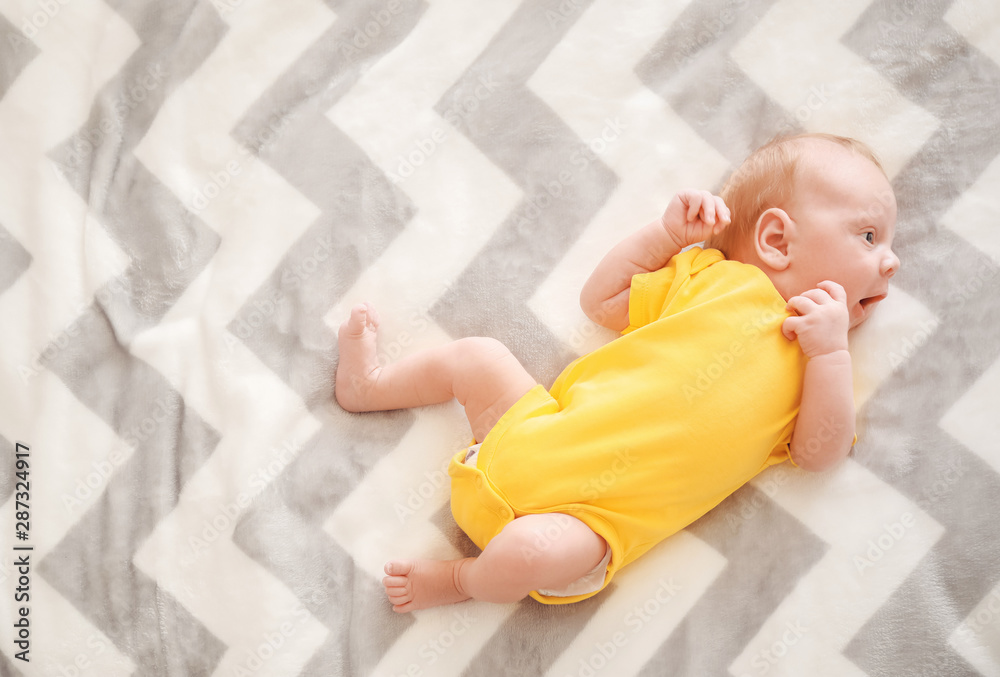Cute little baby lying on bed