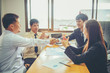 © EKKAPON - Business partners handshaking after signing contract Business teamwork Concept