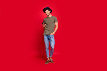 Aufkleber - Full size photo of amazing guy chatting friends holding telephone hands wear casual outfit isolated on red background