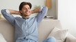 © Prostock-studio - Happy Guy Relaxing Sitting On Sofa At Home