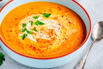 Canvas Print - Carrot and pumpkin cream soup with parsley