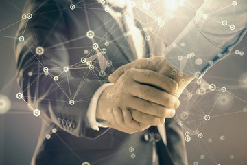 Double exposure of tech drawing on abstract background with two men handshake. Concept of technology in modern business