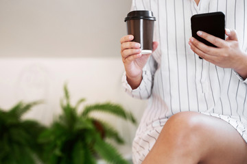 Wall Mural - Woman hands holding mobile smartphone in cafe.