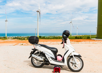 Motorbike stand near Wind turbine farm from clean energy near the sea. Wind power for electricity. Phan Rang, Vietnam