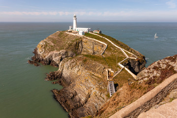 Wall Mural - The South Stack Lighthouse is built on the summit of a small island off the north-west coast of Holy Island, Anglesey, Wales. It was built in 1809 to warn ships of the dangerous rocks below.