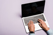 © LIGHTFIELD STUDIOS - cropped view of woman typing on laptop with blank screen on purple